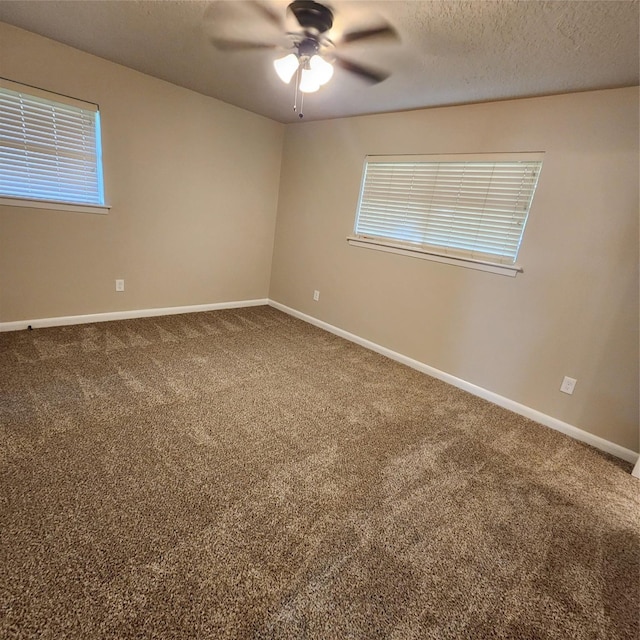 3625 Whatley Dr, Deer Park, TX 77536 - carpeted spare room with a ceiling fan, baseboards, plenty of natural light, and a textured ceiling