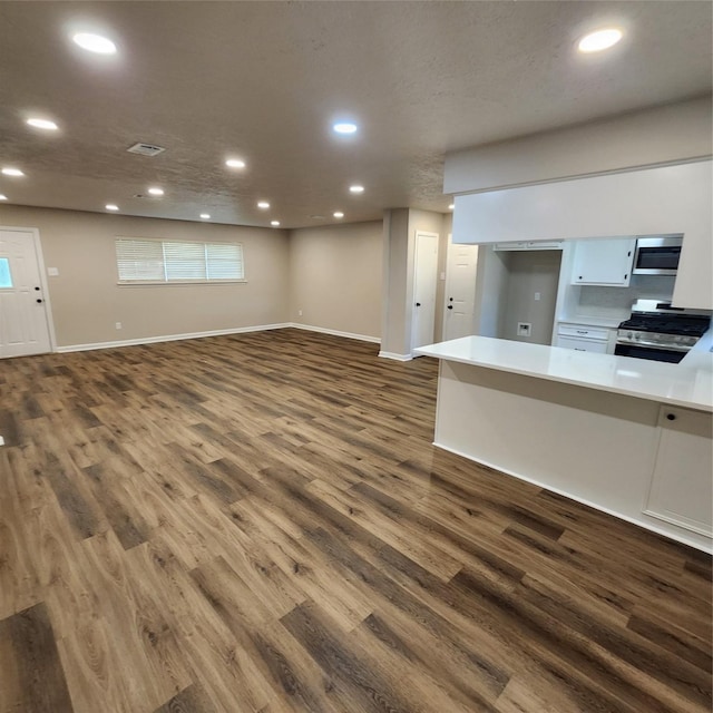 3625 Whatley Dr, Deer Park, TX 77536 - unfurnished living room with dark wood-style floors and recessed lighting