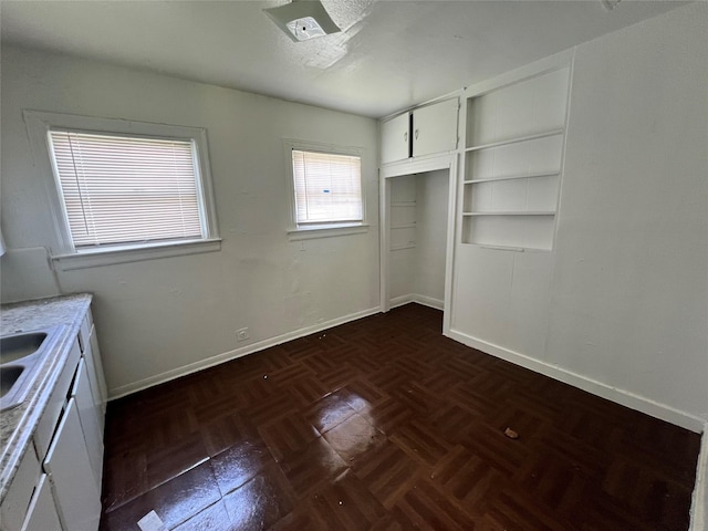 unfurnished bedroom featuring baseboards