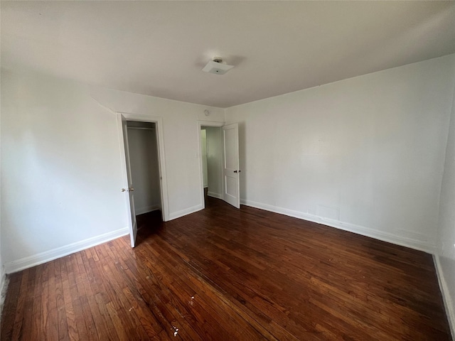unfurnished room featuring dark wood finished floors and baseboards