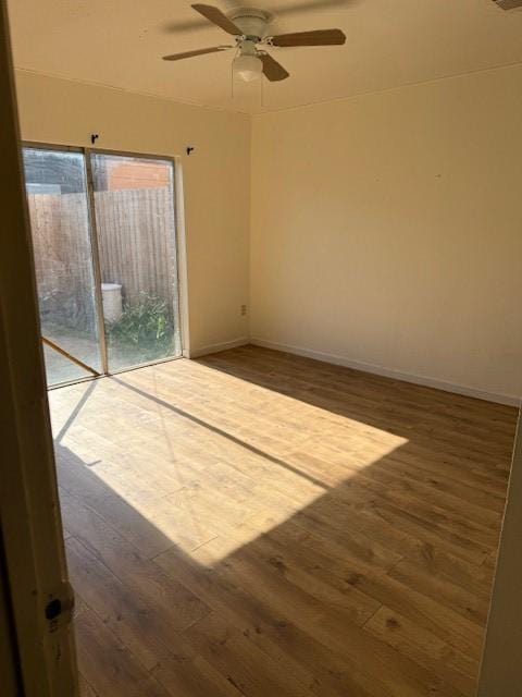 7358 Crownwest St Unit 7358, Houston, TX 77072 - spare room with hardwood / wood-style flooring, a ceiling fan, and baseboards
