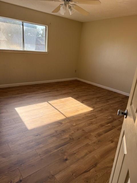 7358 Crownwest St Unit 7358, Houston, TX 77072 - unfurnished room featuring wood finished floors, ceiling fan, and baseboards