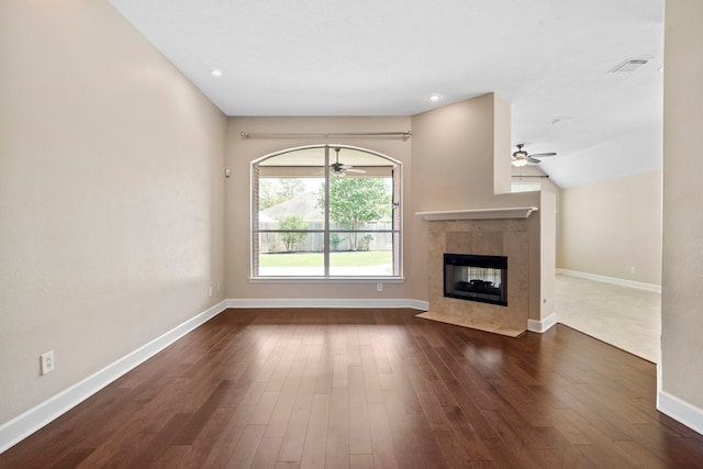 20506 Nellie Gail Trail Ln, Katy, TX 77450 - unfurnished living room featuring ceiling fan, a tile fireplace, baseboards, and dark wood finished floors