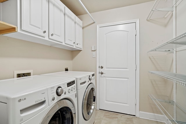 20506 Nellie Gail Trail Ln, Katy, TX 77450 - clothes washing area with washer and clothes dryer, cabinet space, light tile patterned floors, and baseboards
