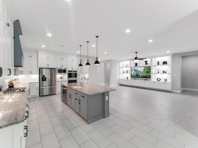 15806 Gibson Grass Ct, Spring, TX 77379 - kitchen featuring stainless steel appliances, a ceiling fan, gray cabinets, recessed lighting, and light stone countertops