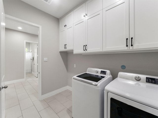 15806 Gibson Grass Ct, Spring, TX 77379 - clothes washing area with cabinet space, separate washer and dryer, baseboards, and light tile patterned floors