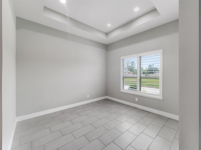 15806 Gibson Grass Ct, Spring, TX 77379 - empty room featuring a raised ceiling, baseboards, recessed lighting, and light tile patterned flooring