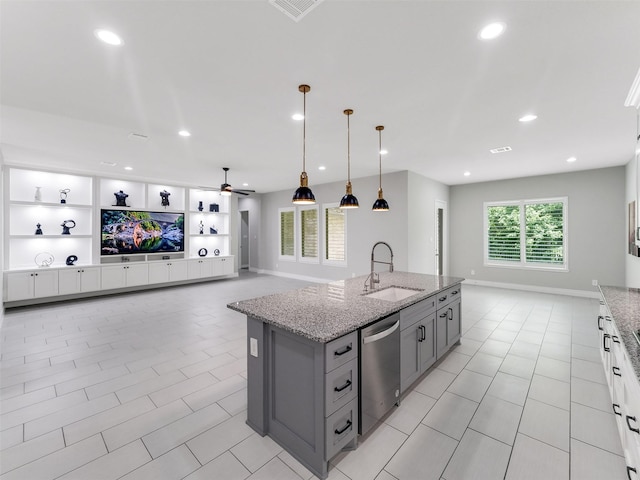 15806 Gibson Grass Ct, Spring, TX 77379 - kitchen with a sink, stainless steel dishwasher, gray cabinetry, light stone countertops, and recessed lighting