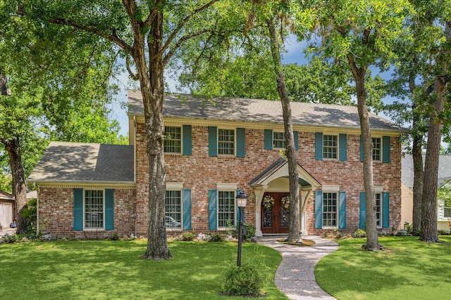 13706 Butterfly Ln, Houston, TX 77079 - view of front of home with a front yard, brick siding, and a shingled roof