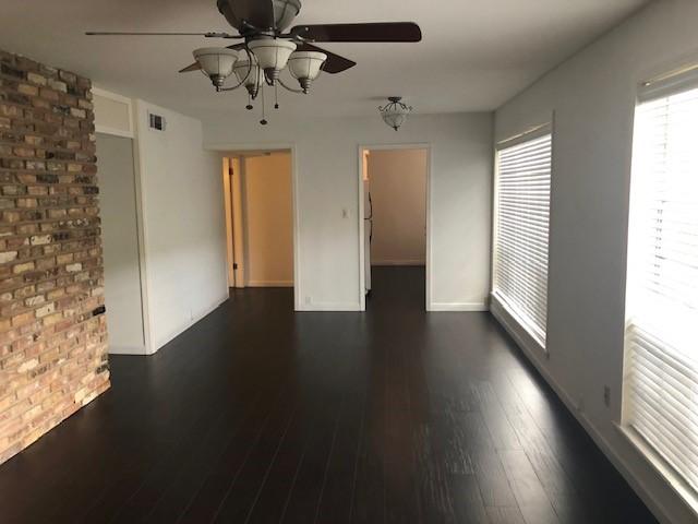 2101 Fountain View Dr Unit 77, Houston, TX 77057 - unfurnished room featuring a ceiling fan, dark wood-style flooring, and baseboards