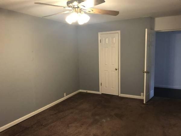 2101 Fountain View Dr Unit 77, Houston, TX 77057 - unfurnished bedroom with baseboards, carpet floors, and a ceiling fan