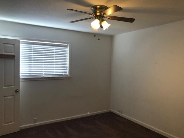 2101 Fountain View Dr Unit 77, Houston, TX 77057 - empty room featuring a ceiling fan, baseboards, and dark colored carpet