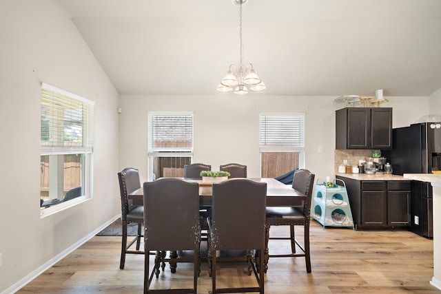 11311 Cascading Stream Way, Houston, TX 77044 - dining room featuring a chandelier, plenty of natural light, lofted ceiling, and light wood-style floors