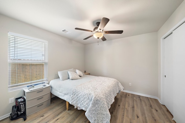 11311 Cascading Stream Way, Houston, TX 77044 - bedroom featuring a closet, wood finished floors, baseboards, and ceiling fan