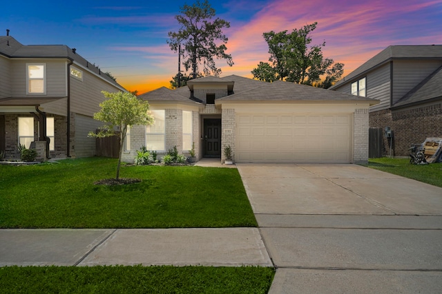 11311 Cascading Stream Way, Houston, TX 77044 - view of front facade with a garage, brick siding, a front lawn, and concrete driveway
