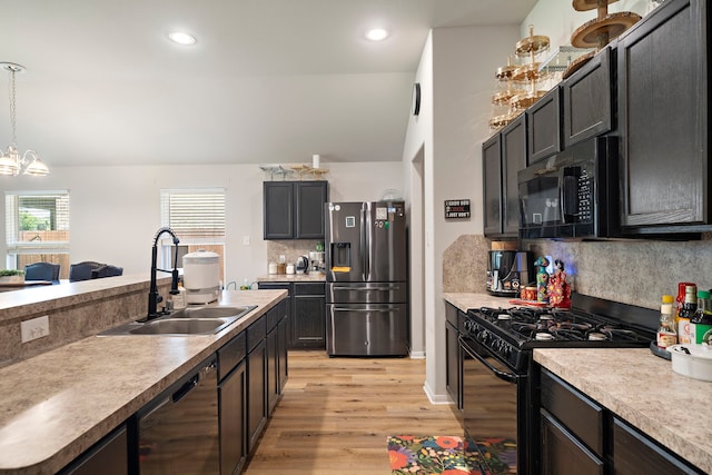 11311 Cascading Stream Way, Houston, TX 77044 - kitchen with black appliances, a sink, light wood-style flooring, decorative backsplash, and a chandelier