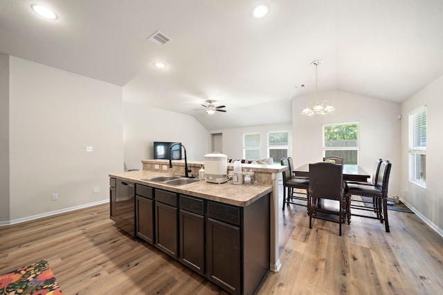 11311 Cascading Stream Way, Houston, TX 77044 - kitchen with a sink, dishwashing machine, lofted ceiling, dark brown cabinets, and light wood-style floors