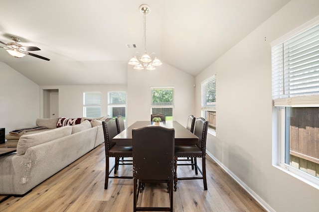 11311 Cascading Stream Way, Houston, TX 77044 - dining room featuring light wood-style flooring, lofted ceiling, a chandelier, a ceiling fan, and baseboards