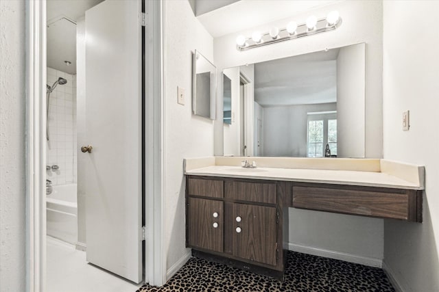 full bath with baseboards, vanity, and shower / bathtub combination
