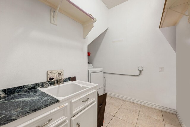 19509 Desna Dr, Porter, TX 77365 - laundry area featuring a sink, washer / dryer, light tile patterned floors, and baseboards