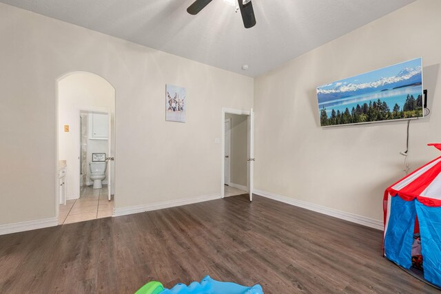 19509 Desna Dr, Porter, TX 77365 - game room with wood finished floors, ceiling fan, arched walkways, and baseboards