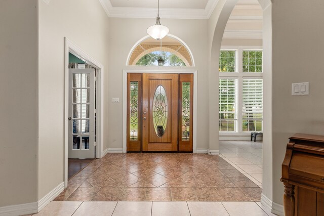 19509 Desna Dr, Porter, TX 77365 - tiled entrance foyer with ornamental molding, baseboards, arched walkways, and a towering ceiling