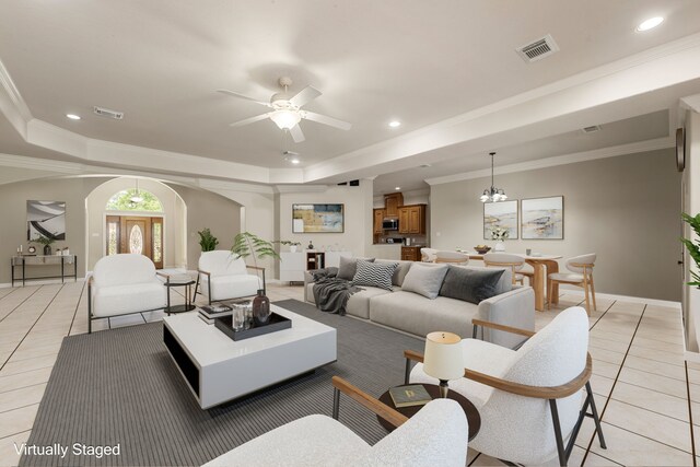 19509 Desna Dr, Porter, TX 77365 - living room with light tile patterned floors, arched walkways, ceiling fan, a tray ceiling, and baseboards