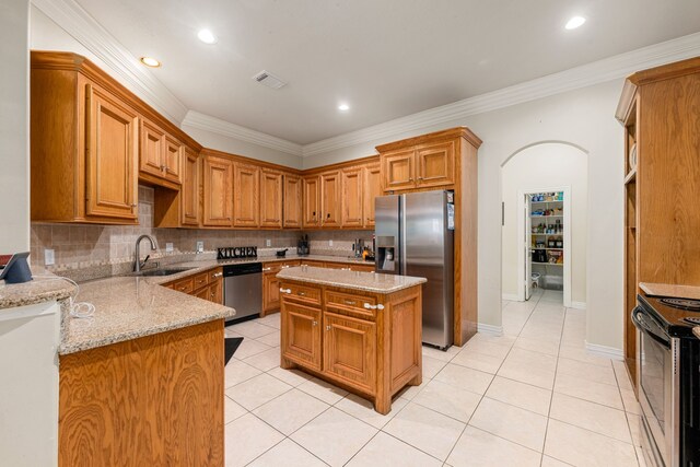 19509 Desna Dr, Porter, TX 77365 - kitchen featuring stainless steel appliances, a sink, tasteful backsplash, crown molding, and light stone countertops