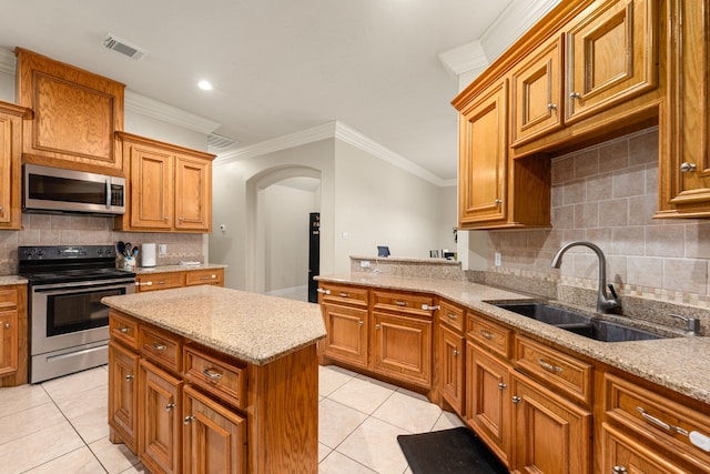 19509 Desna Dr, Porter, TX 77365 - kitchen featuring stainless steel appliances, a sink, arched walkways, light tile patterned floors, and backsplash