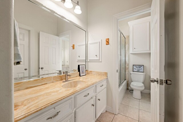 19509 Desna Dr, Porter, TX 77365 - bathroom featuring vanity, tile patterned floors, toilet, shower / bath combination with glass door, and baseboards