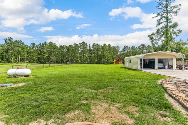19509 Desna Dr, Porter, TX 77365 - view of yard featuring a detached carport and driveway