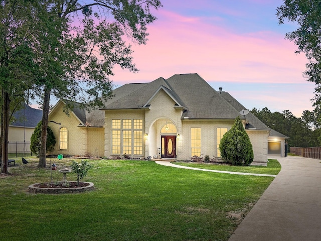 19509 Desna Dr, Porter, TX 77365 - view of front facade with brick siding, a garage, driveway, and a shingled roof