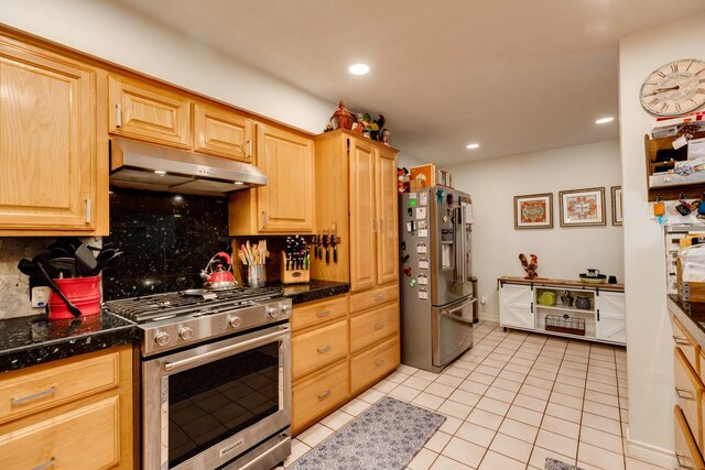 29 Quintana Dr, Galveston, TX 77554 - kitchen featuring appliances with stainless steel finishes, under cabinet range hood, backsplash, light brown cabinets, and light tile patterned floors