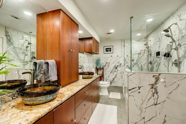29 Quintana Dr, Galveston, TX 77554 - full bathroom featuring tile walls, toilet, a marble finish shower, vanity, and recessed lighting