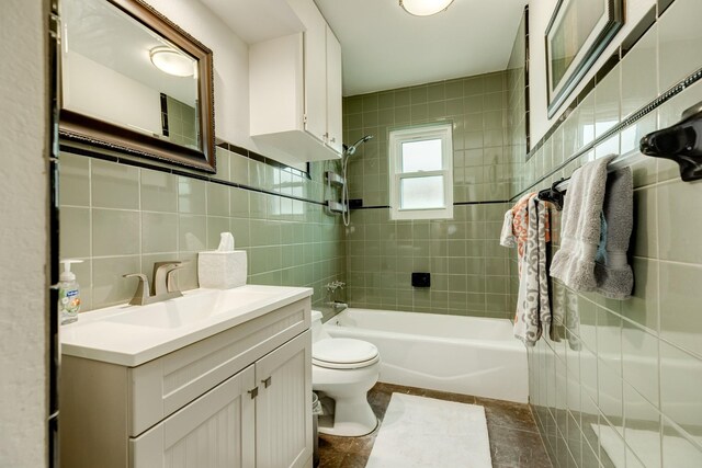 29 Quintana Dr, Galveston, TX 77554 - bathroom with toilet,  shower combination, vanity, and tile walls