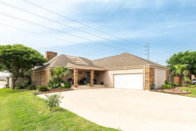 29 Quintana Dr, Galveston, TX 77554 - view of front facade with driveway, a front lawn, a garage, brick siding, and a chimney