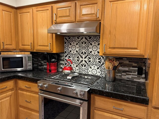29 Quintana Dr, Galveston, TX 77554 - kitchen featuring stainless steel appliances, extractor fan, tasteful backsplash, and dark countertops