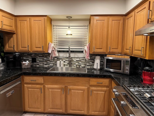 29 Quintana Dr, Galveston, TX 77554 - kitchen featuring appliances with stainless steel finishes, tasteful backsplash, a sink, and brown cabinets