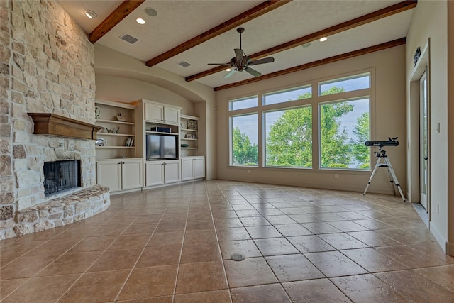 19926 Gemstone Dr, Montgomery, TX 77356 - unfurnished living room with ceiling fan, beamed ceiling, a fireplace, built in features, and baseboards