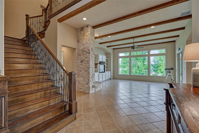 19926 Gemstone Dr, Montgomery, TX 77356 - stairway with a ceiling fan, beamed ceiling, tile patterned flooring, ornate columns, and recessed lighting