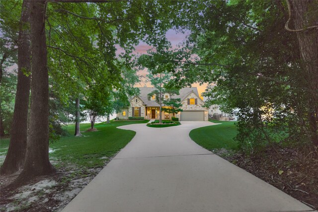 19926 Gemstone Dr, Montgomery, TX 77356 - view of home's community with driveway, a yard, and a garage