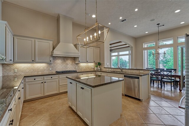 19926 Gemstone Dr, Montgomery, TX 77356 - kitchen with wall chimney exhaust hood, stainless steel appliances, ornamental molding, a sink, and tasteful backsplash
