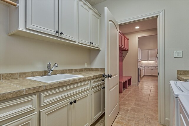 19926 Gemstone Dr, Montgomery, TX 77356 - laundry area featuring cabinet space, washing machine and clothes dryer, and recessed lighting