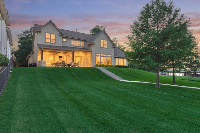 19926 Gemstone Dr, Montgomery, TX 77356 - back of property at dusk featuring stucco siding and a patio area