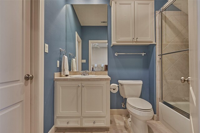 19926 Gemstone Dr, Montgomery, TX 77356 - full bathroom featuring vanity, toilet, baseboards, enclosed tub / shower combo, and tile patterned floors