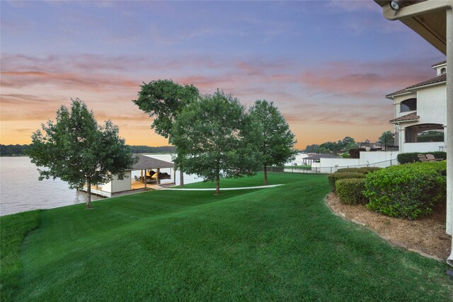 19926 Gemstone Dr, Montgomery, TX 77356 - yard at dusk featuring a water view