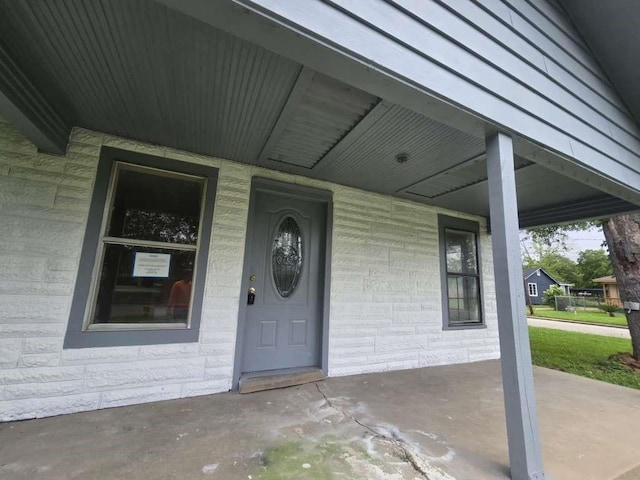 1300 Burbank St, Baytown, TX 77520 - doorway to property featuring covered porch