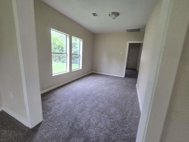 1300 Burbank St, Baytown, TX 77520 - carpeted empty room with baseboards