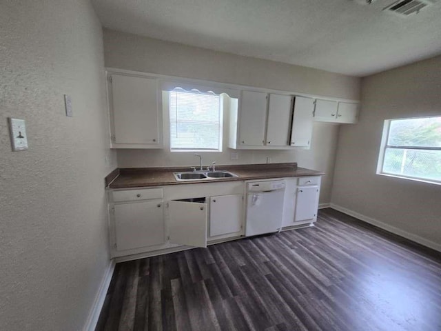 1300 Burbank St, Baytown, TX 77520 - kitchen with dishwasher, a sink, a textured wall, dark wood-style floors, and white cabinetry