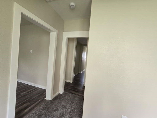 1300 Burbank St, Baytown, TX 77520 - corridor featuring dark carpet and baseboards
